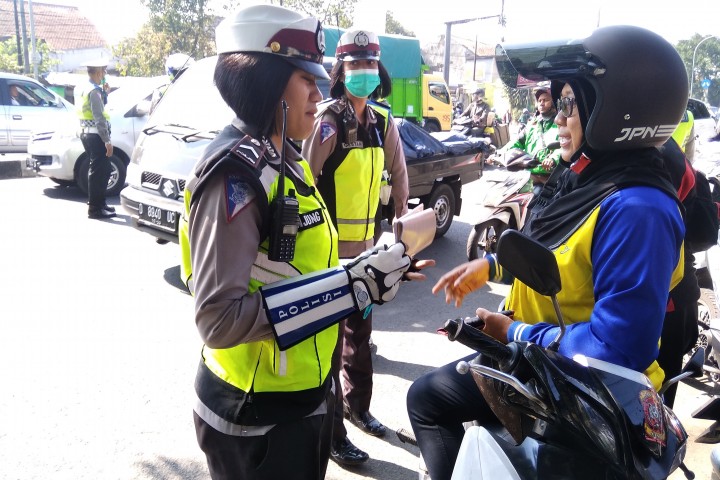 Polwan saat menilang seorang pengendara sepeda motor